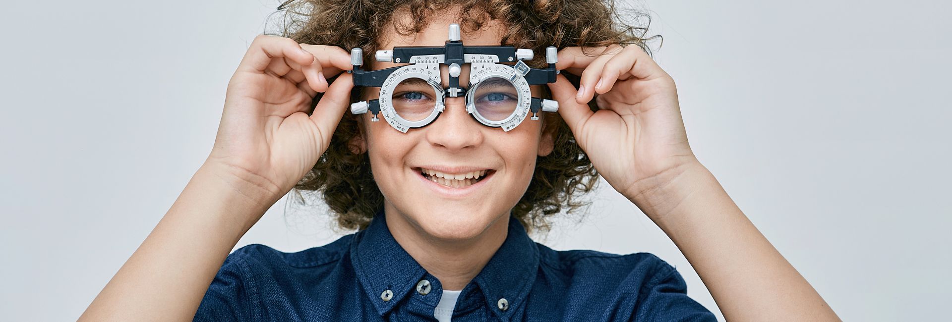 Optician fitting a trial frame during a professional eye examination at Jennings Opticians