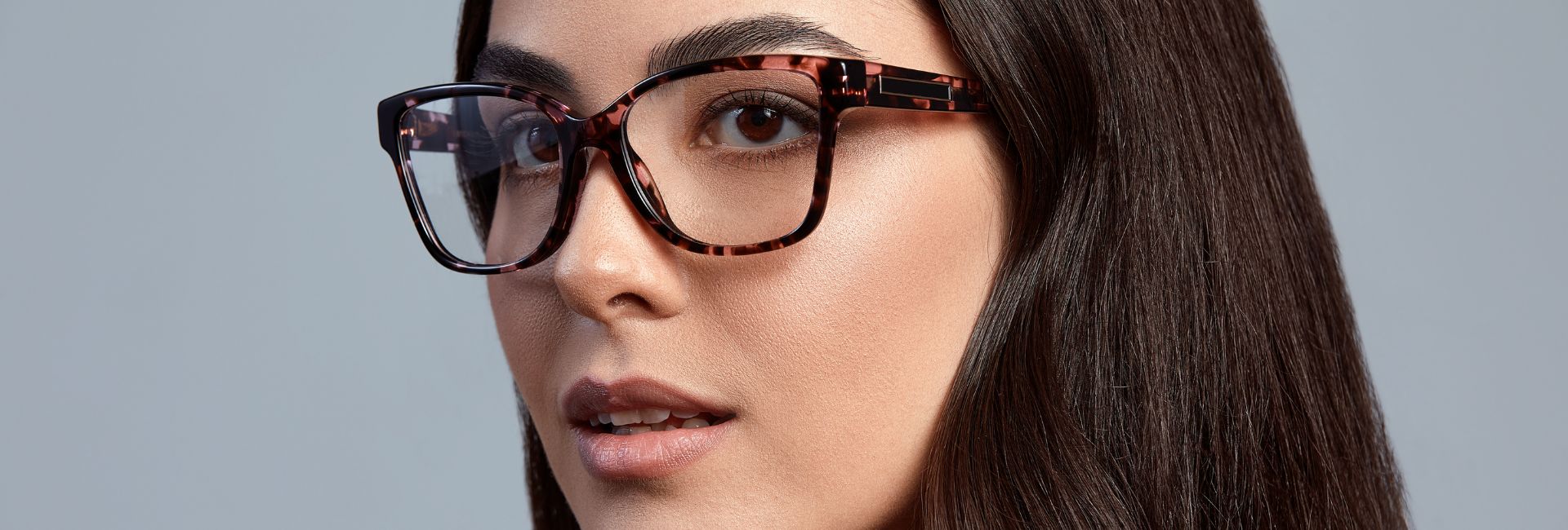 Happy woman wearing stylish glasses from Jennings Opticians, Wythenshawe